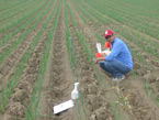 Dipak collecting samples in a field
