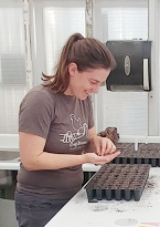 Shannon Carmody planting seeds in a tray